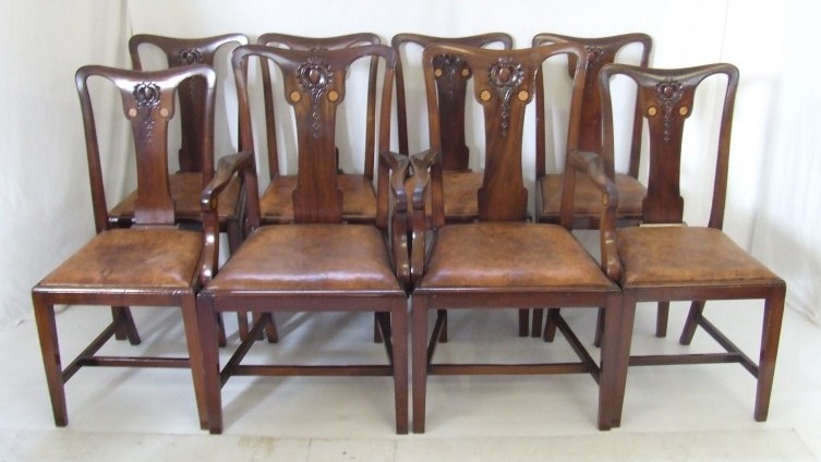 EIght splat back mahogany dining chairs, including two carvers, with marquetry, drop-in leather seats on tapering square legs (£360)